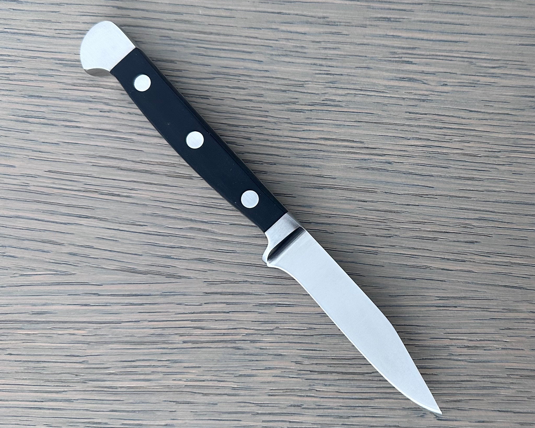 Güde Alpha Series 3-inch Sharp Point paring knife with a pointed tip and black Hostaform handle