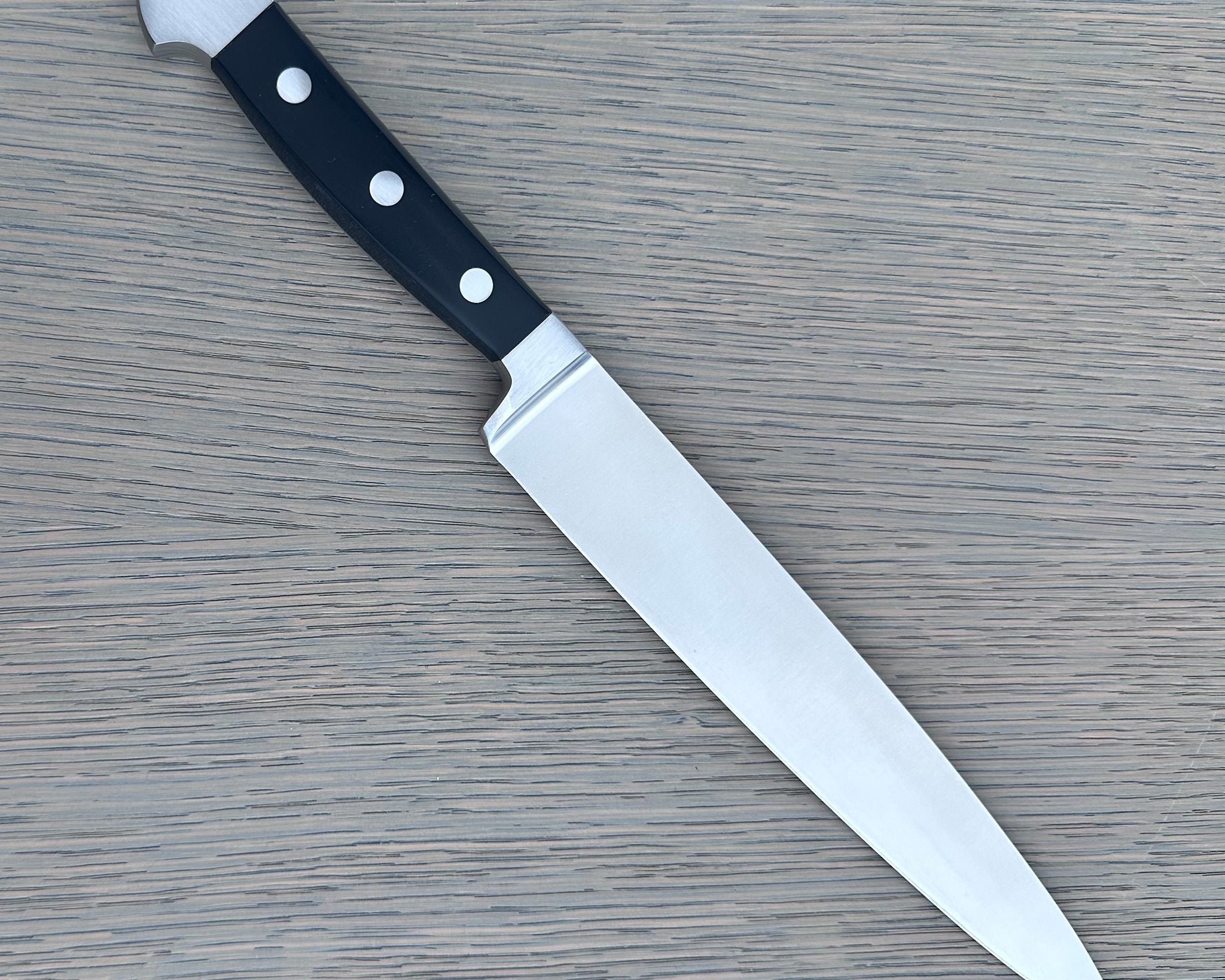 Güde Alpha Series Carving Knife 8-inch, forged from a single bar of steel for a harder, thicker blade