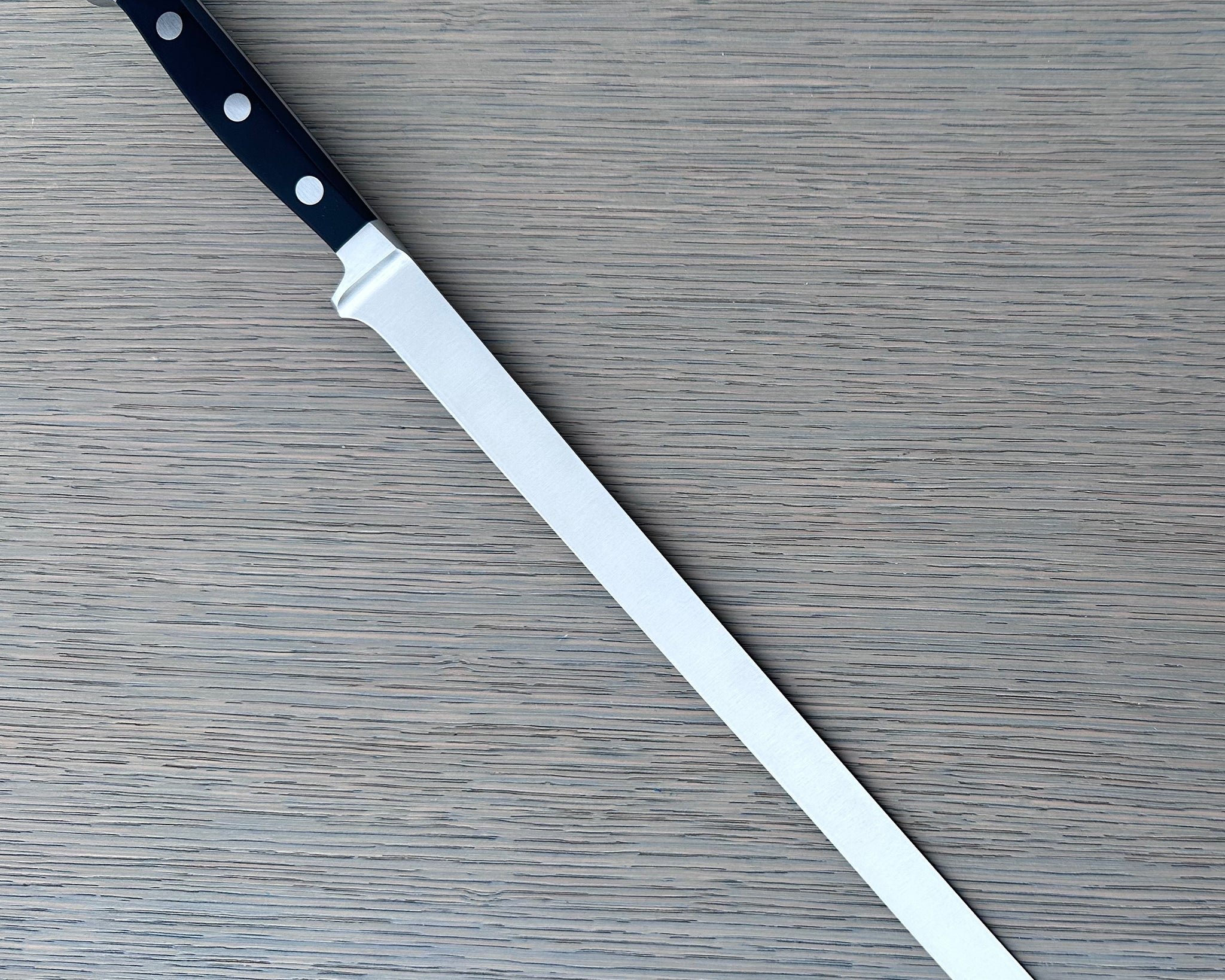 Güde Alpha Series Salmon Slicer 10-inch, forged from a single bar of steel for a harder, thicker blade