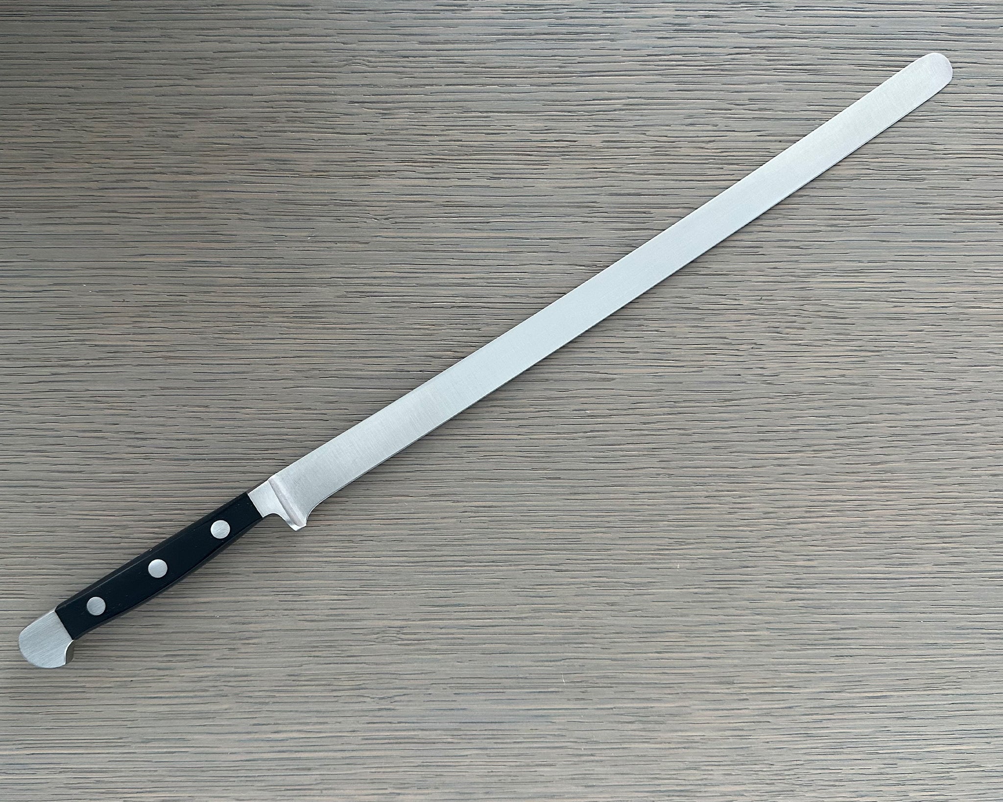 Güde Alpha Series Salmon Slicer 12-inch, forged from a single bar of steel for a harder, thicker blade