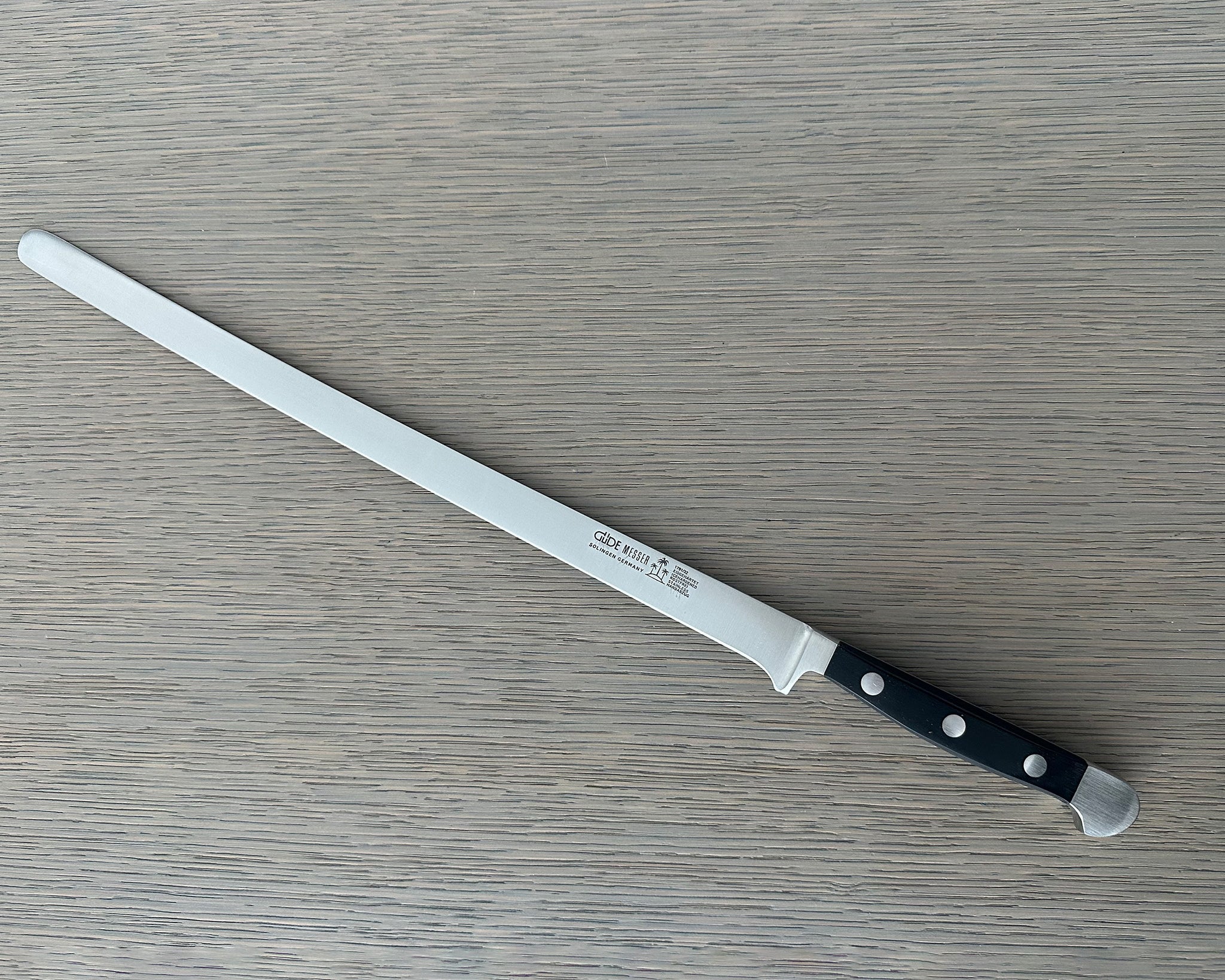 Güde Alpha Salmon Slicer 12-in with black Hostaform handle, hand-forged in Solingen, Germany