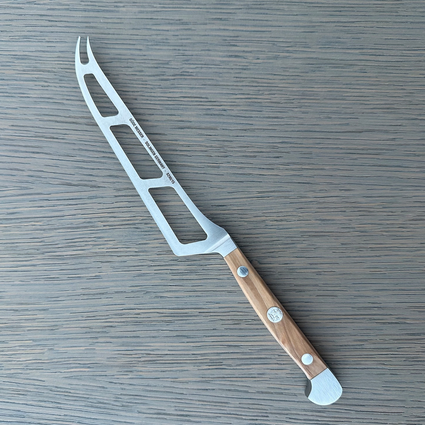 Gude Alpha Olive Series Forged Double Bolster Cheese Knife 6-in, Olivewood Handle