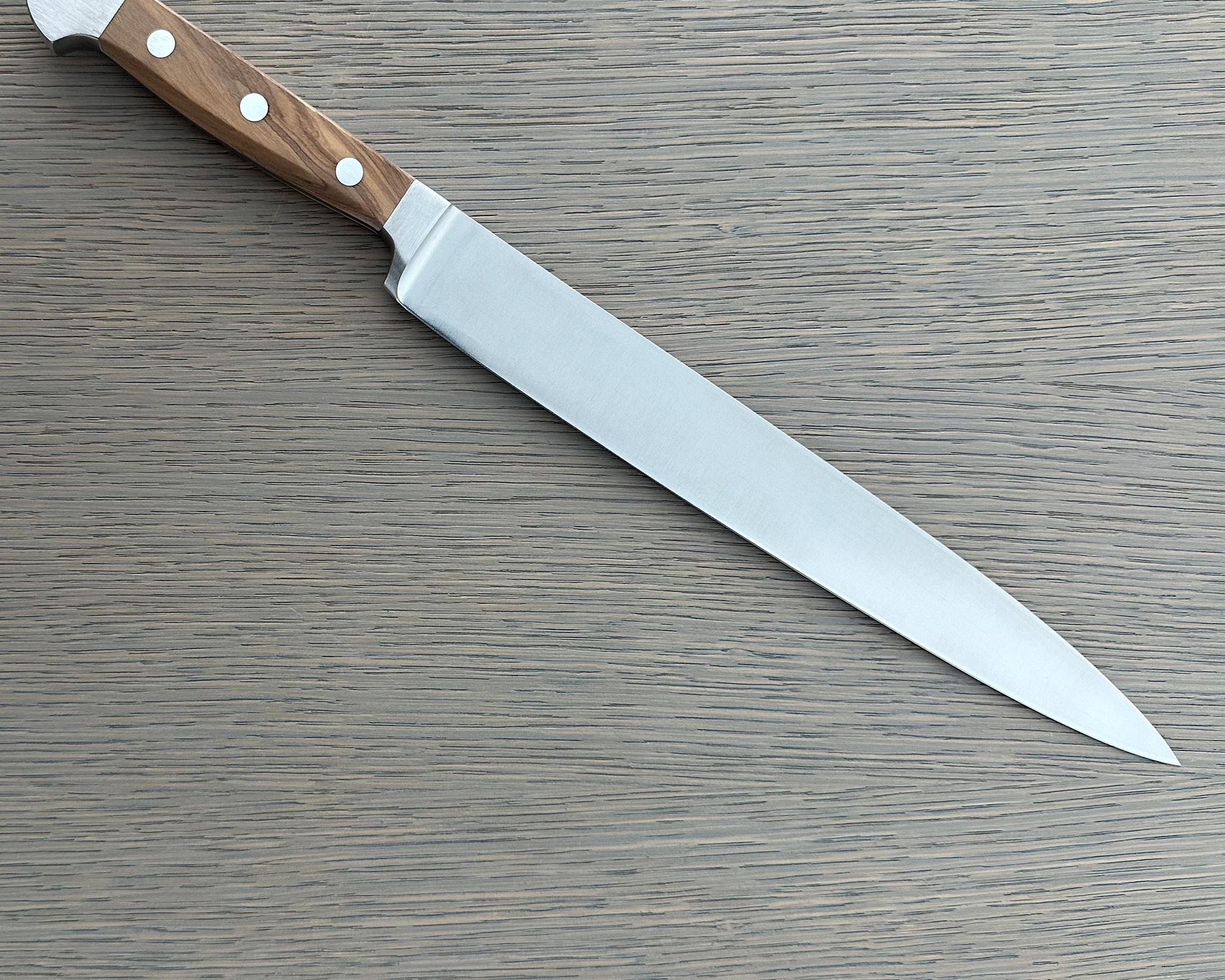 Güde Alpha Olive Series Slicing Knife 10-inch, forged from a single bar of steel for a harder, thicker blade